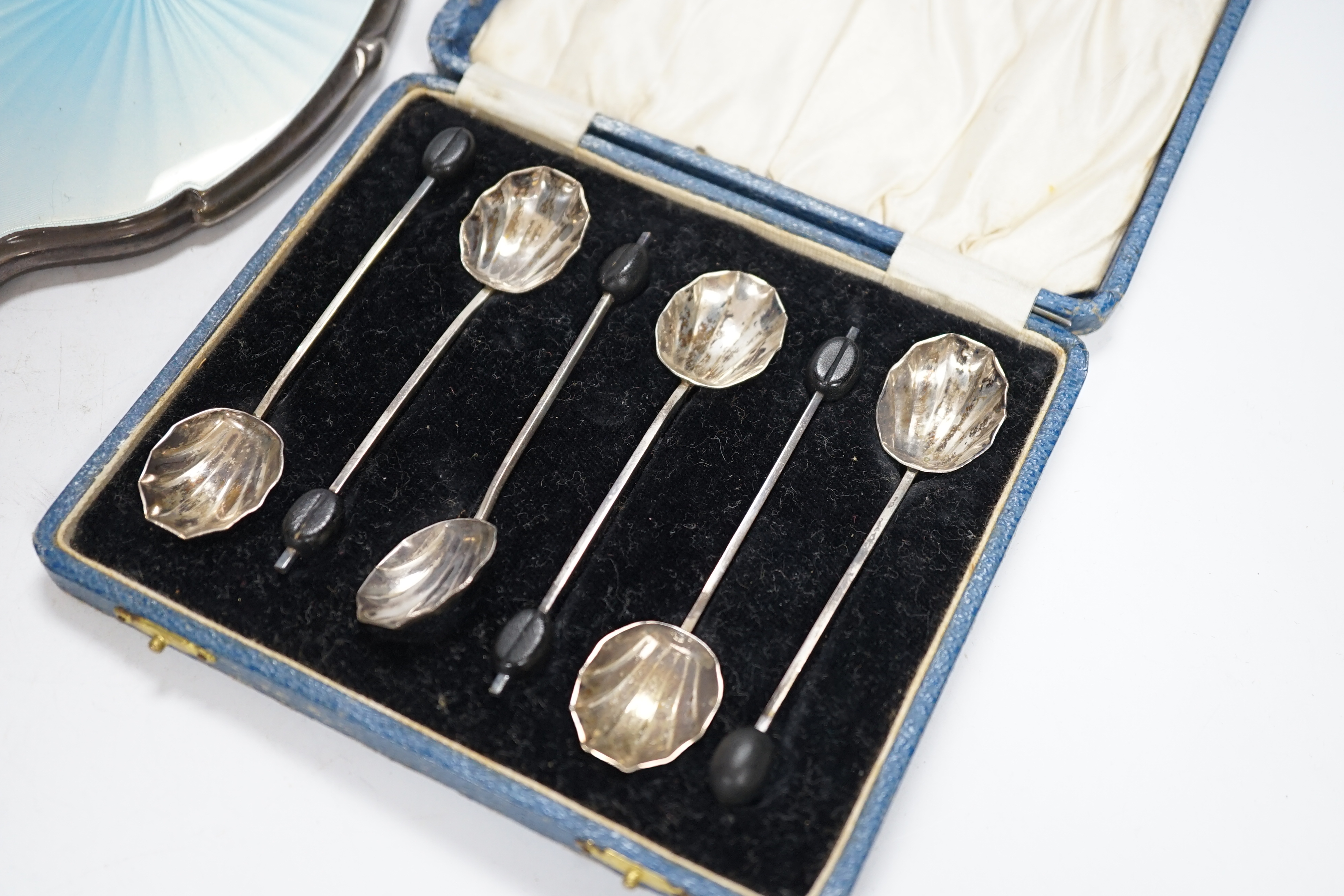 A George V silver claret jug mount, Walker & Hall, Sheffield, 1912, three silver and enamel dressing table items including a hand mirror and a cased set of six silver bean end coffee spoons.